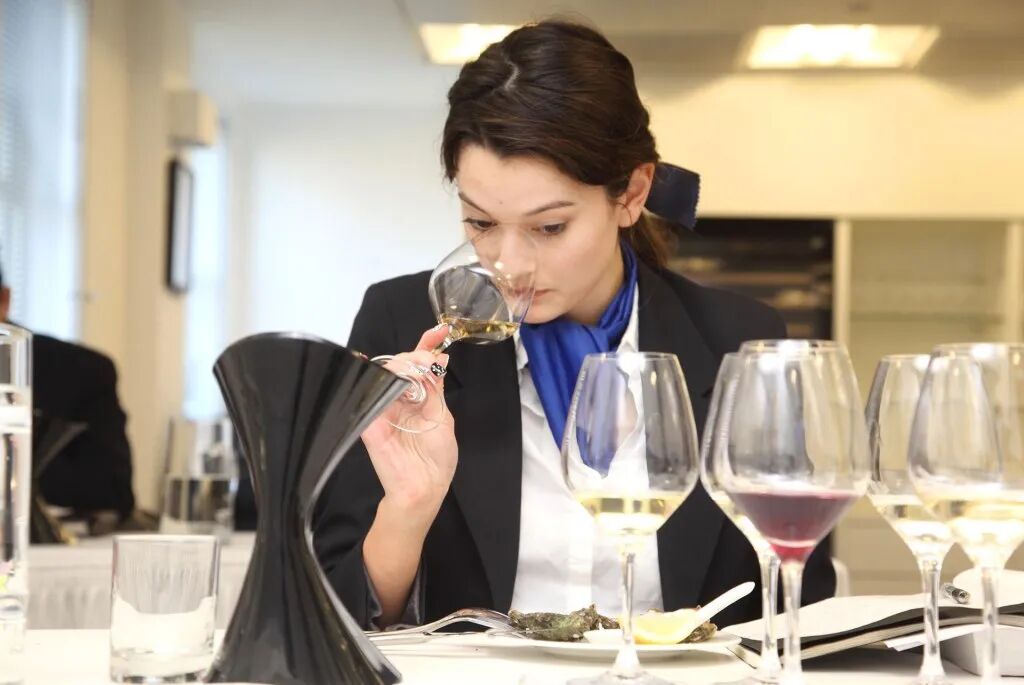 a woman holding a glass of wine
