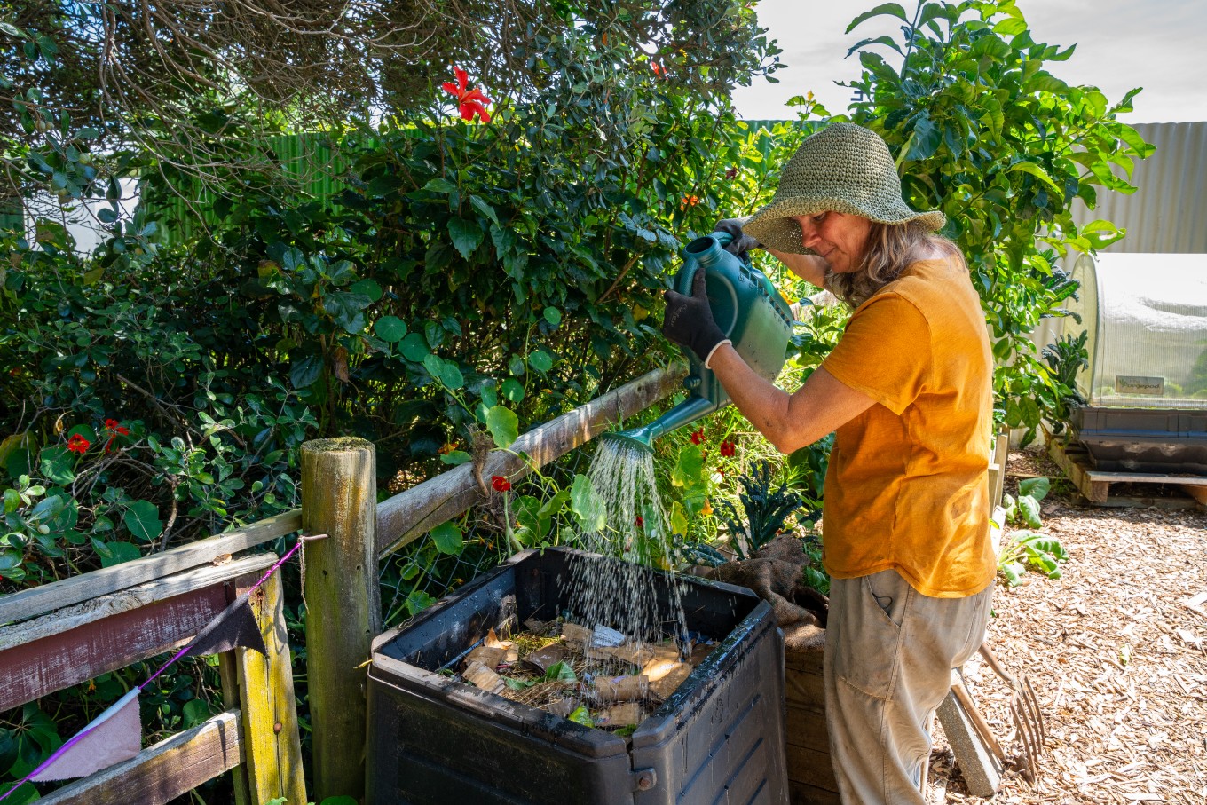 a-person-watering-their-garden