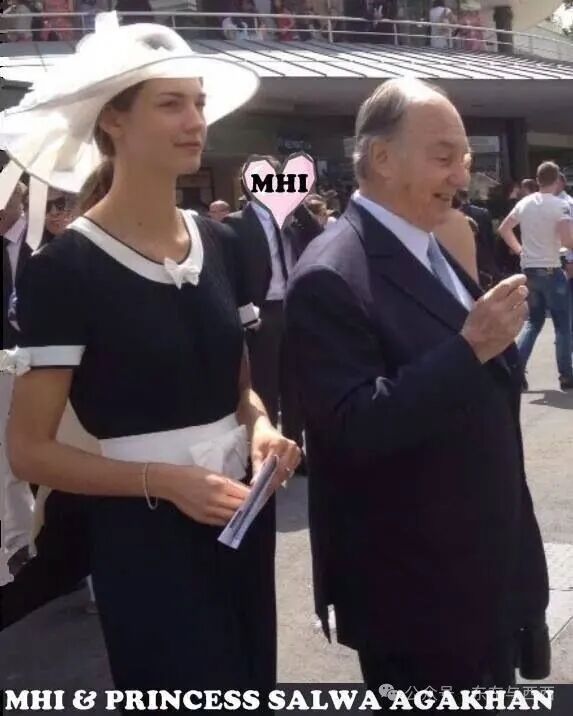 This may contain: two people standing next to each other in front of a crowd wearing suits and hats