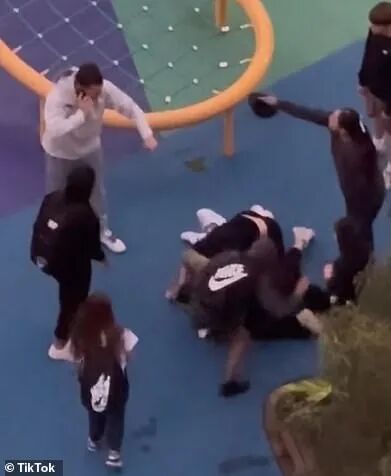 两名年轻人跳到这名女子身上，而她的男伴则大声呼救