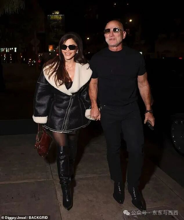 She was walking hand in hand with the Amazon founder (right), who kept it casual in a black T-shirt and trousers