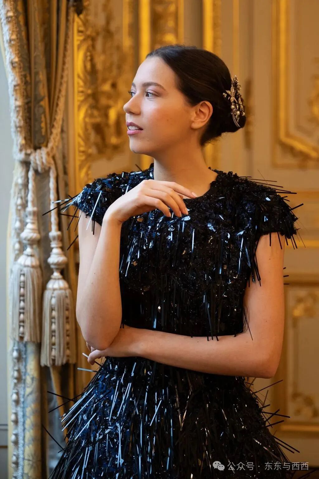 Image may contain Clothing Dress Formal Wear Evening Dress Person Adult Black Hair Hair Face and Head