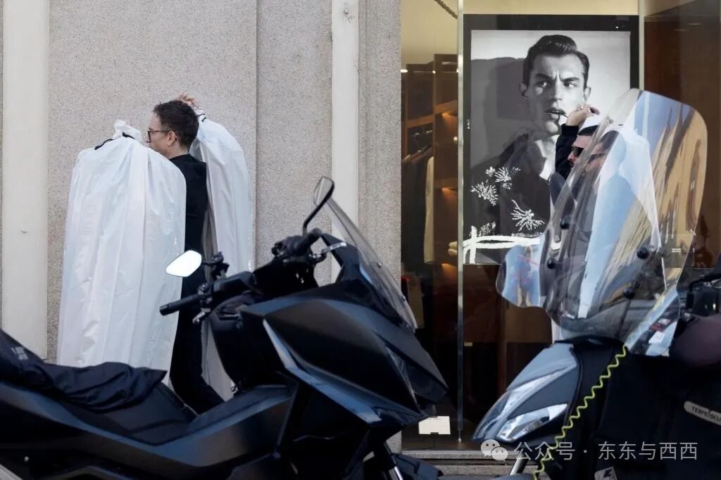 An assistant seemingly holds Lauren Sanchez and Jeff Bezos' wedding attire.