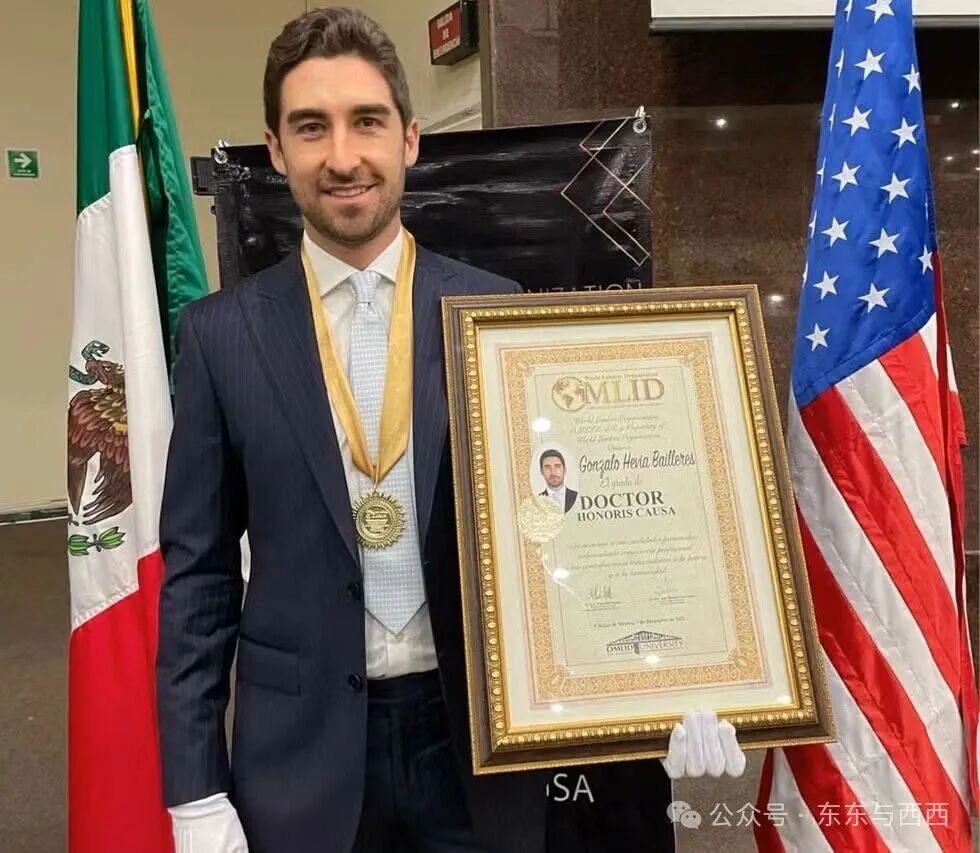 Gonzalo Hevia Baill&egrave;res holding an award and a Doctor Honoris Causa certificate.