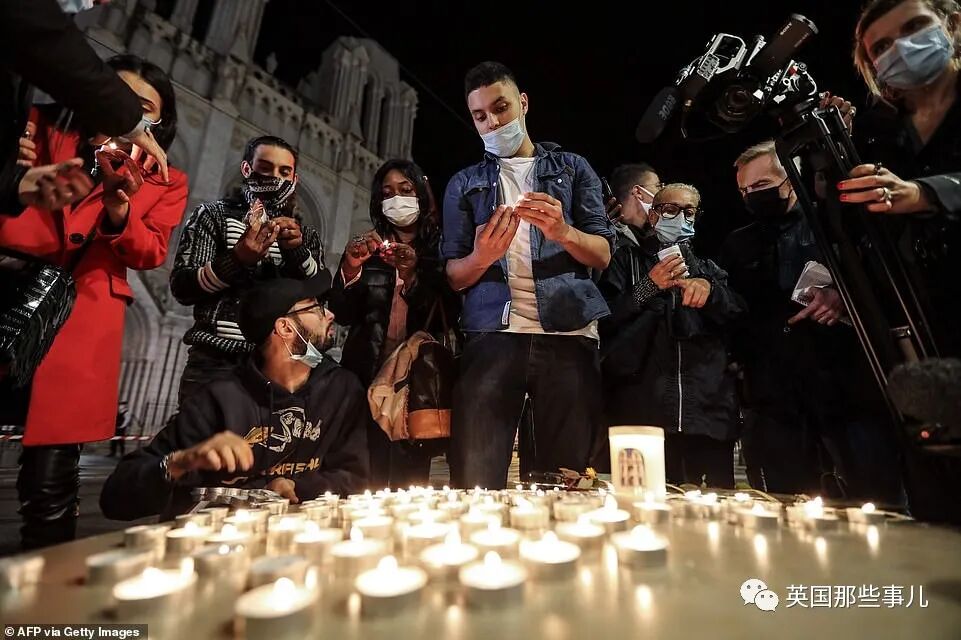 35014024-8892233-People_light_candles_outside_the_Notre_Dame_de_l_Assomption_Basi-a-13_1603999311025.jpg