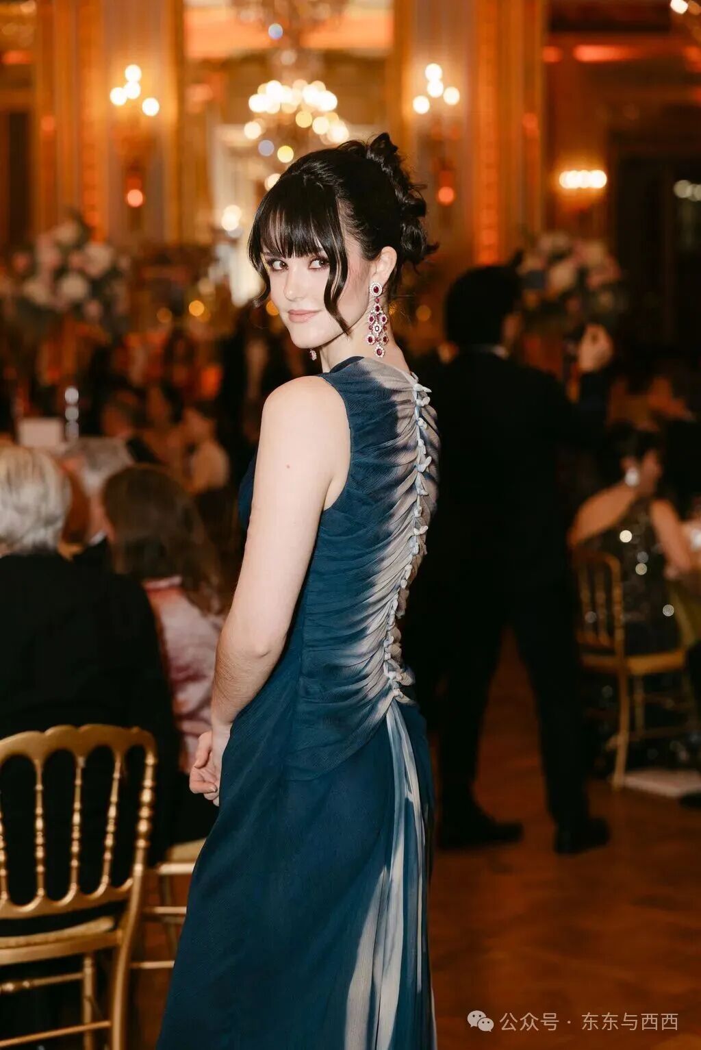Image may contain Clothing Dress Formal Wear Evening Dress Black Hair Hair Person Fashion Gown Adult and Urban